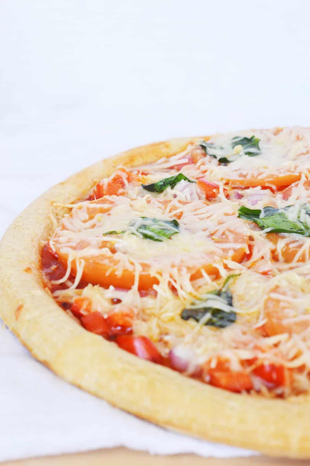 healthy pizza loaded with veggies, made with a whole grain crust, and topped with gooey mozzarella and fresh parmesan