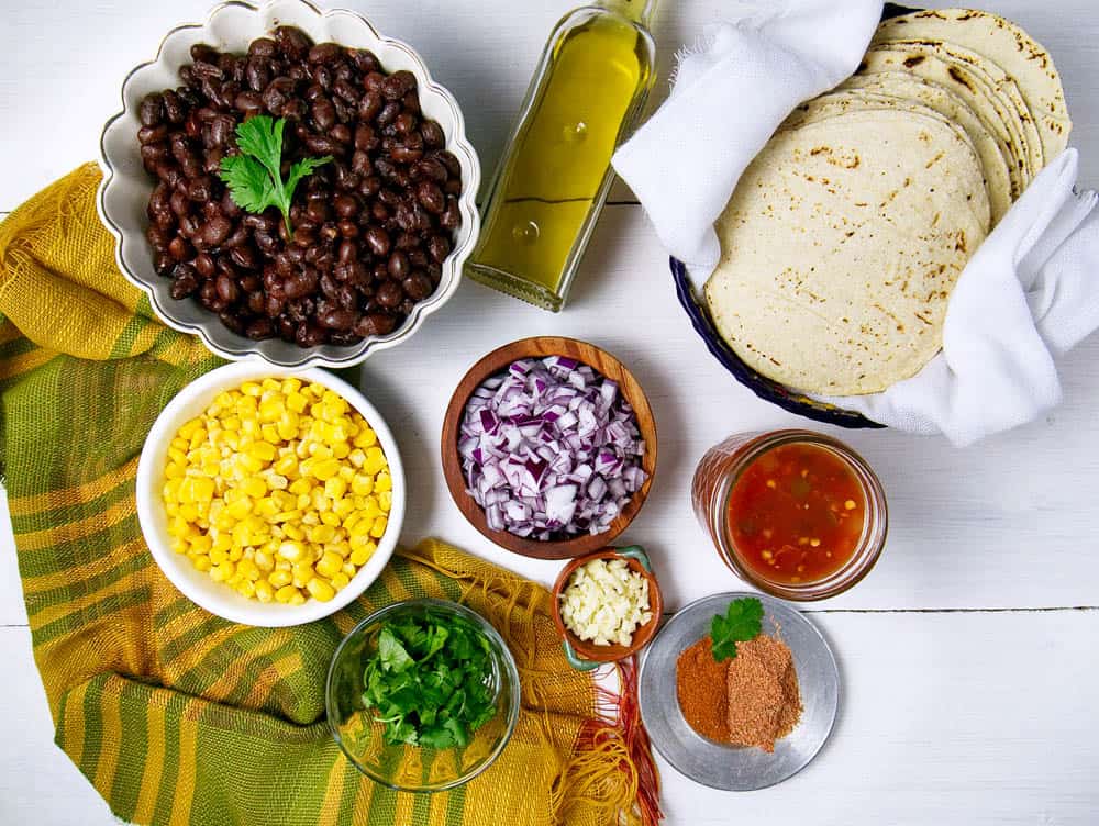 Ingredients for black bean mexican flautas displayed on white background