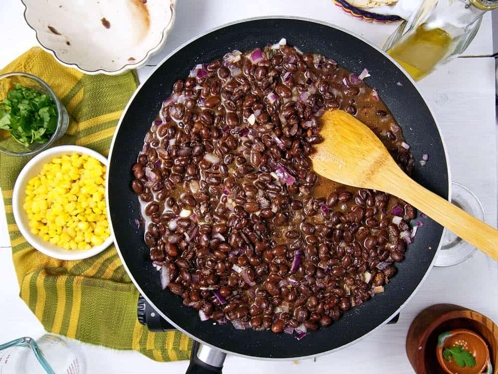 Cooked beans in a frying pan.