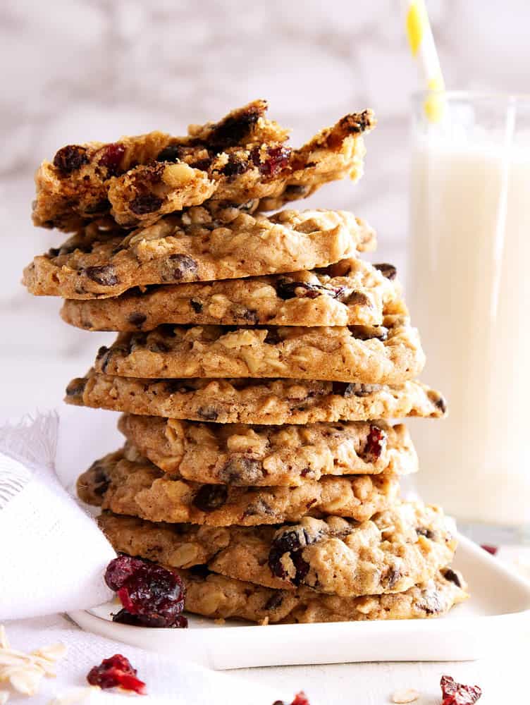Baked Vegan Oatmeal Chocolate Chip Cookies with Cherries stacked on top of each other