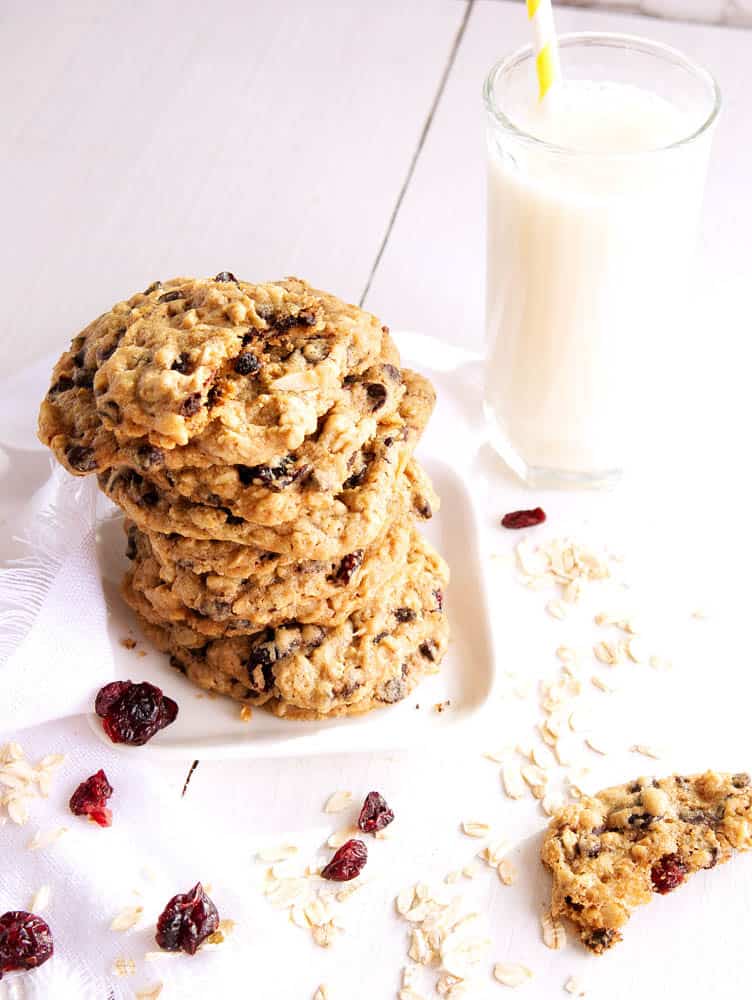 vegan oatmeal Chocolate chip cookies on a plate with a glass of milk.