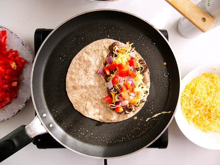 black bean healthy quesadillas in a pan being cooked
