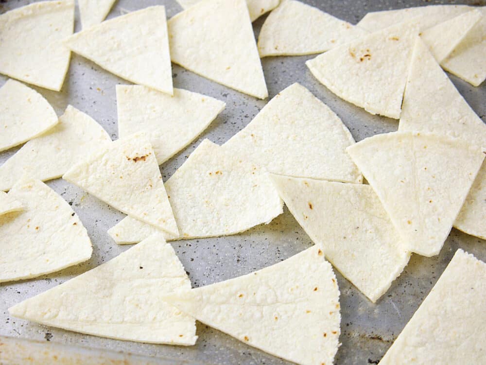 corn tortilla triangles ready to be baked in the oven