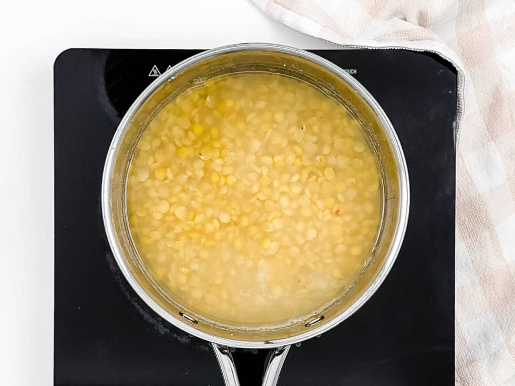 Lentils steaming in a pot on the stove.