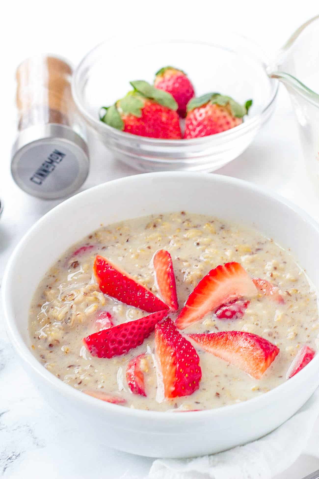 strawberries and cream oatmeal, strawberry oatmeal in a white bowl