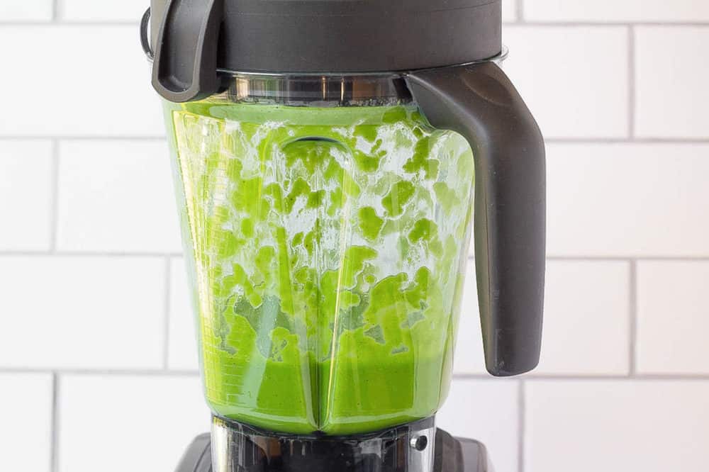 The kale smoothie blended up in a blender. 