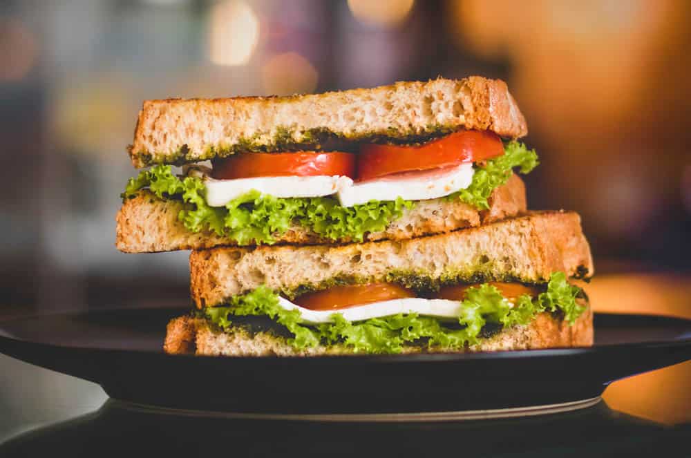 lunchbox makeover: vegetarian sandwich on sprouted wheat bread with tomatoes, cheese and lettuce