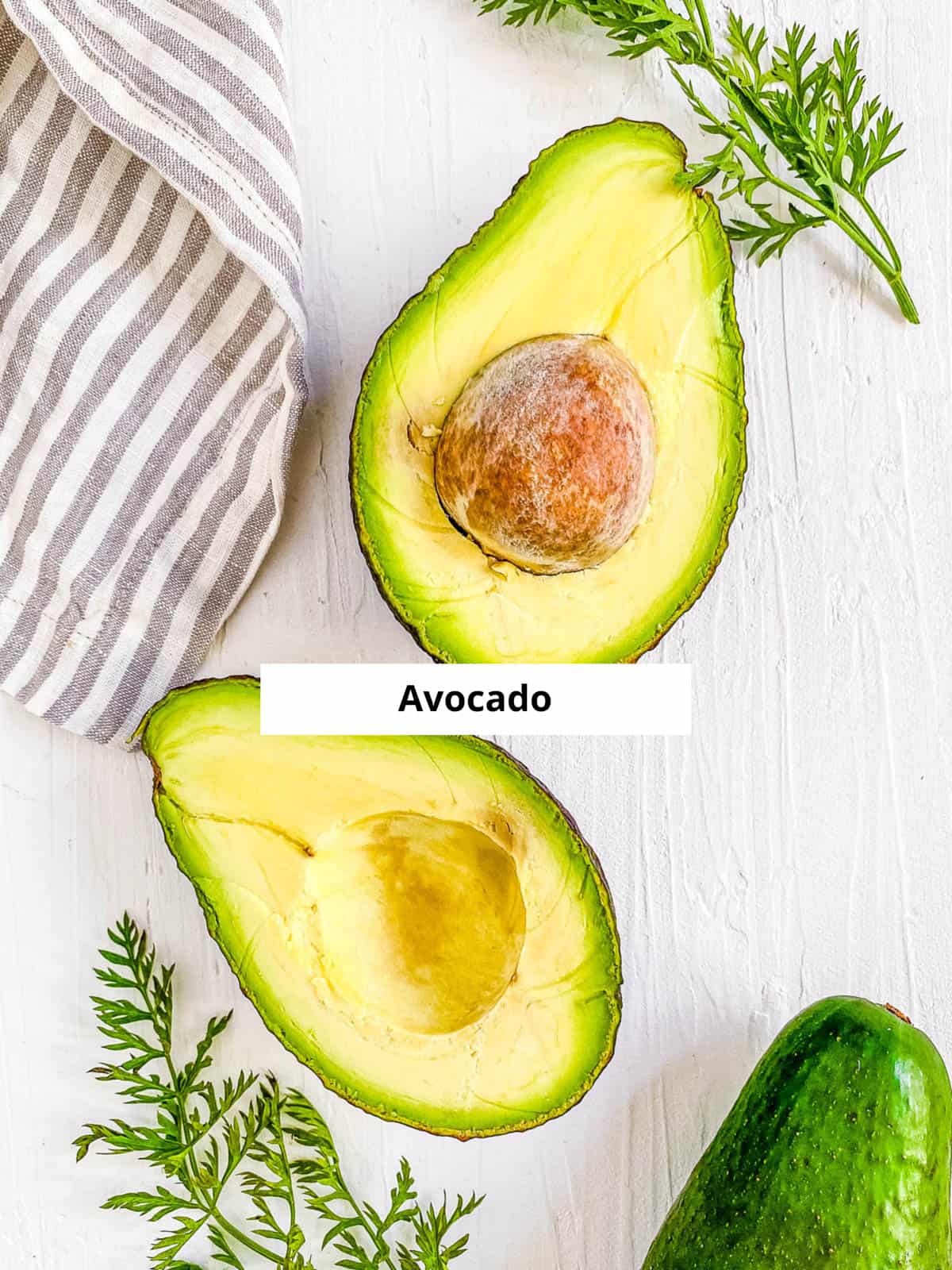 Ingredients for avocado puree baby food recipe on a white background.