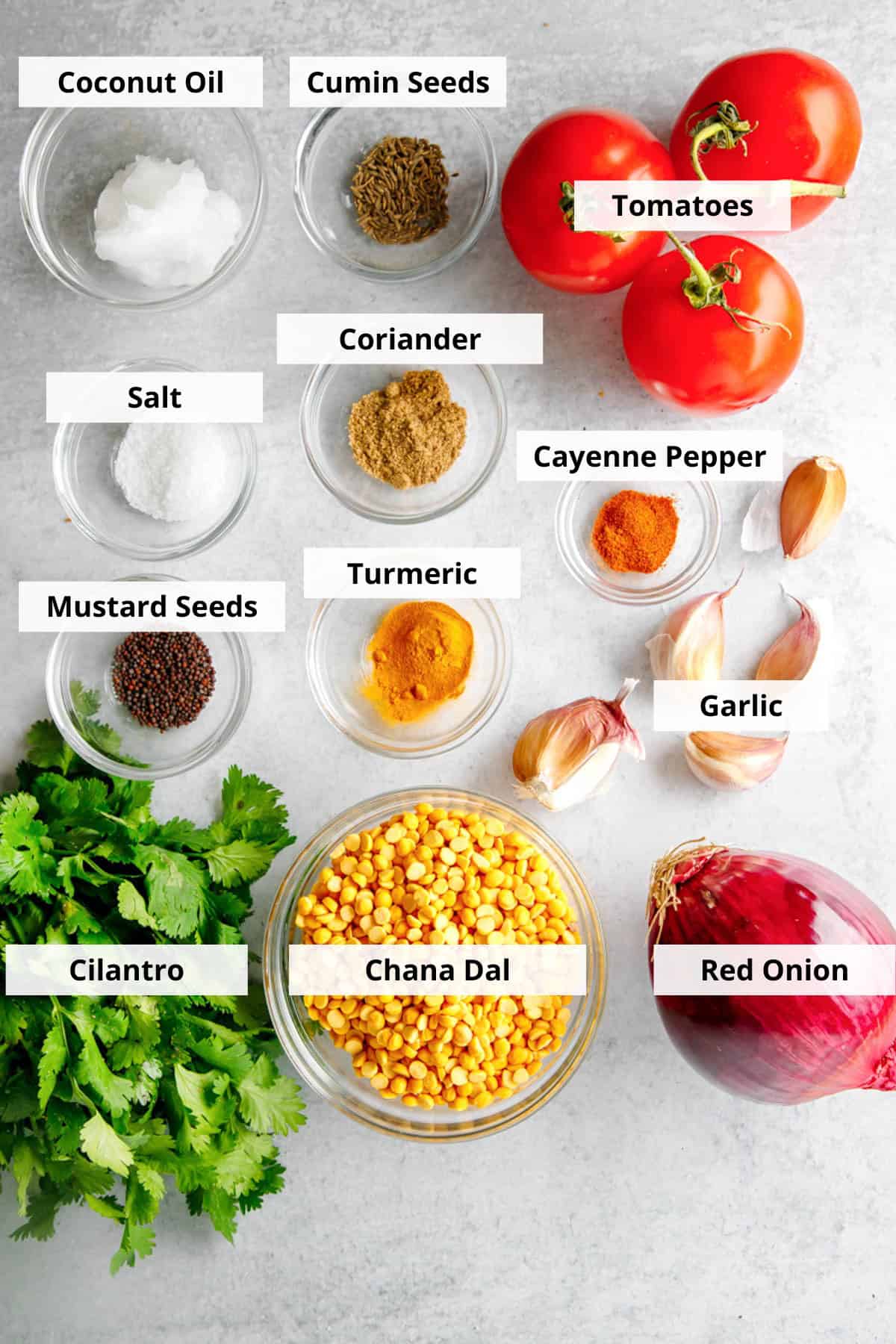 Ingredients for a crock pot dal recipe all on a marble background.