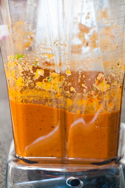 onion, bell pepper, cilantro, oregano, garlic, and ancho chile peppers in a blender