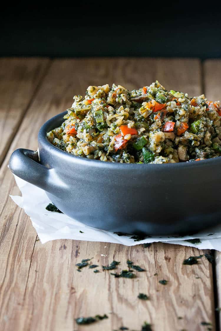 Superfood Stir Fry Cauliflower Rice in a blue bowl sitting on a wooden surface Superfood Stir Fry Cauliflower Rice in a blue bowl sitting on a wooden surface