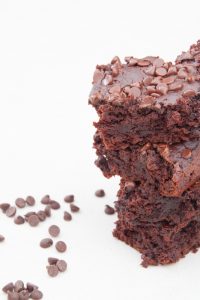 gluten free brownies stacked on top of each other against a white background