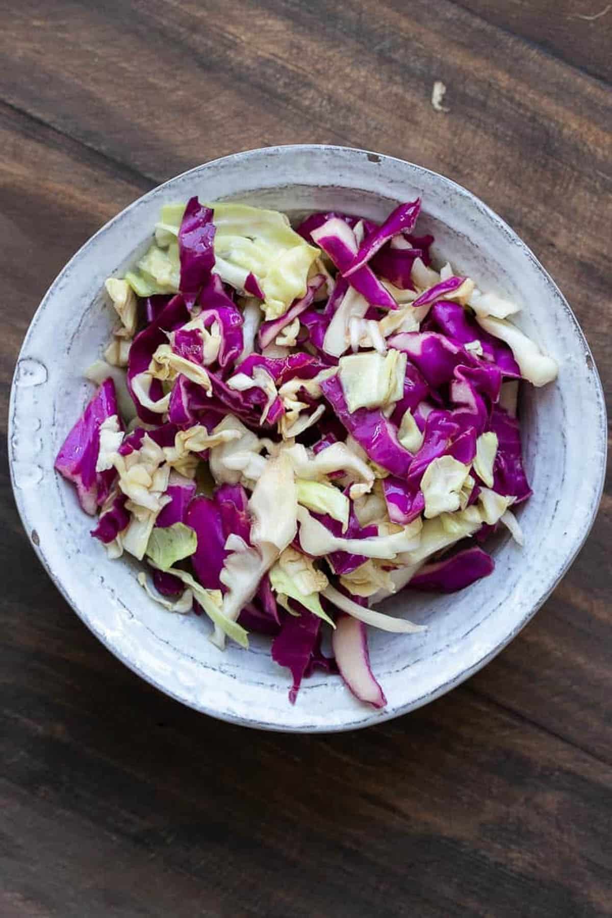 Cabbage sliced in a white bowl.