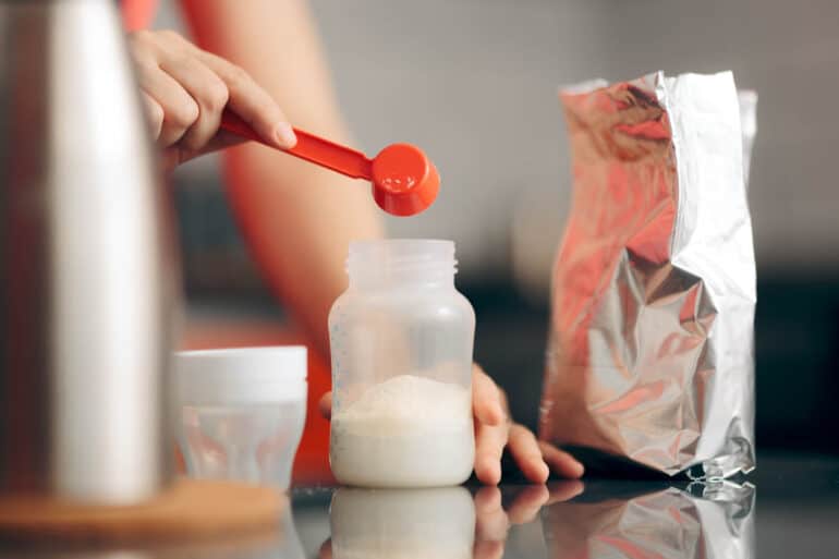Goat milk formula being prepared in a bottle.
