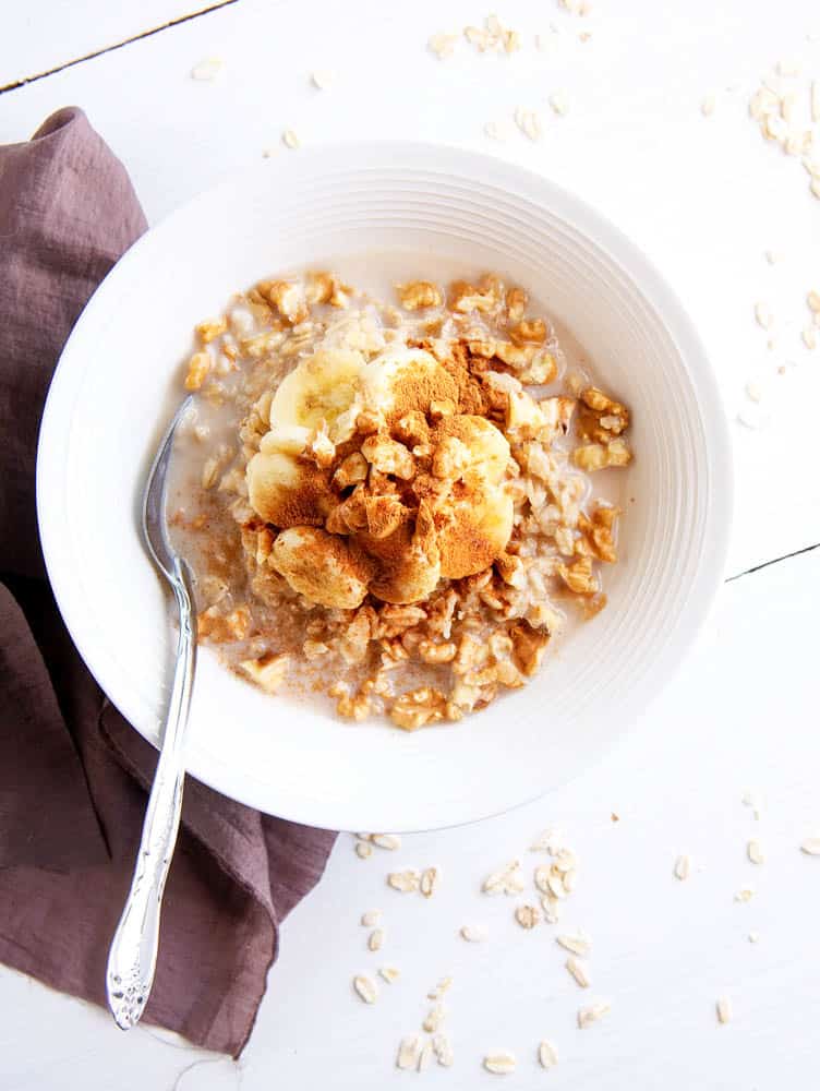 Top shot of Banana Bread Oatmeal in a white bowl - plant based breakfast ideas