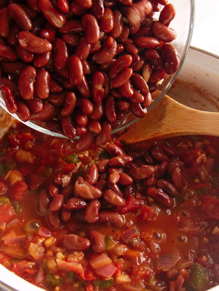 Kidney beans being poured into the pot