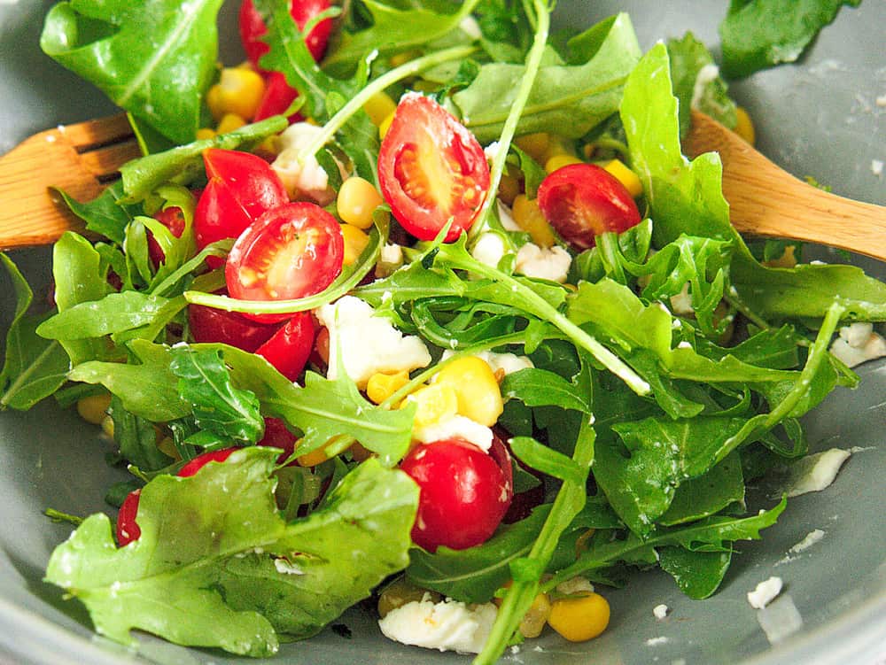 Tossed mixed green salad, with cherry tomatoes and cheese. 