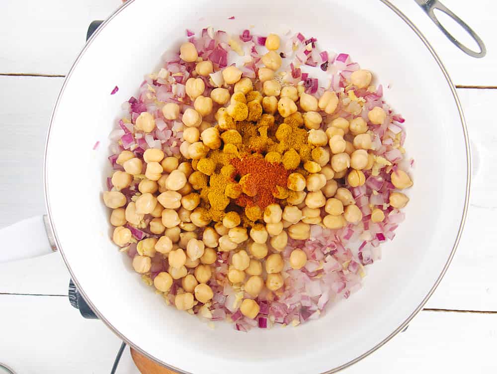 chickpeas and spices added to onions/garlic/ginger in pan