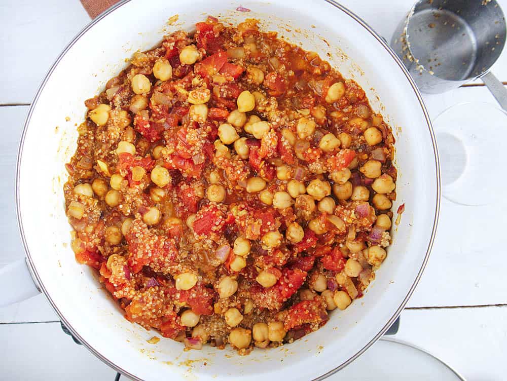 curried chickpeas and quinoa cooking in a pan