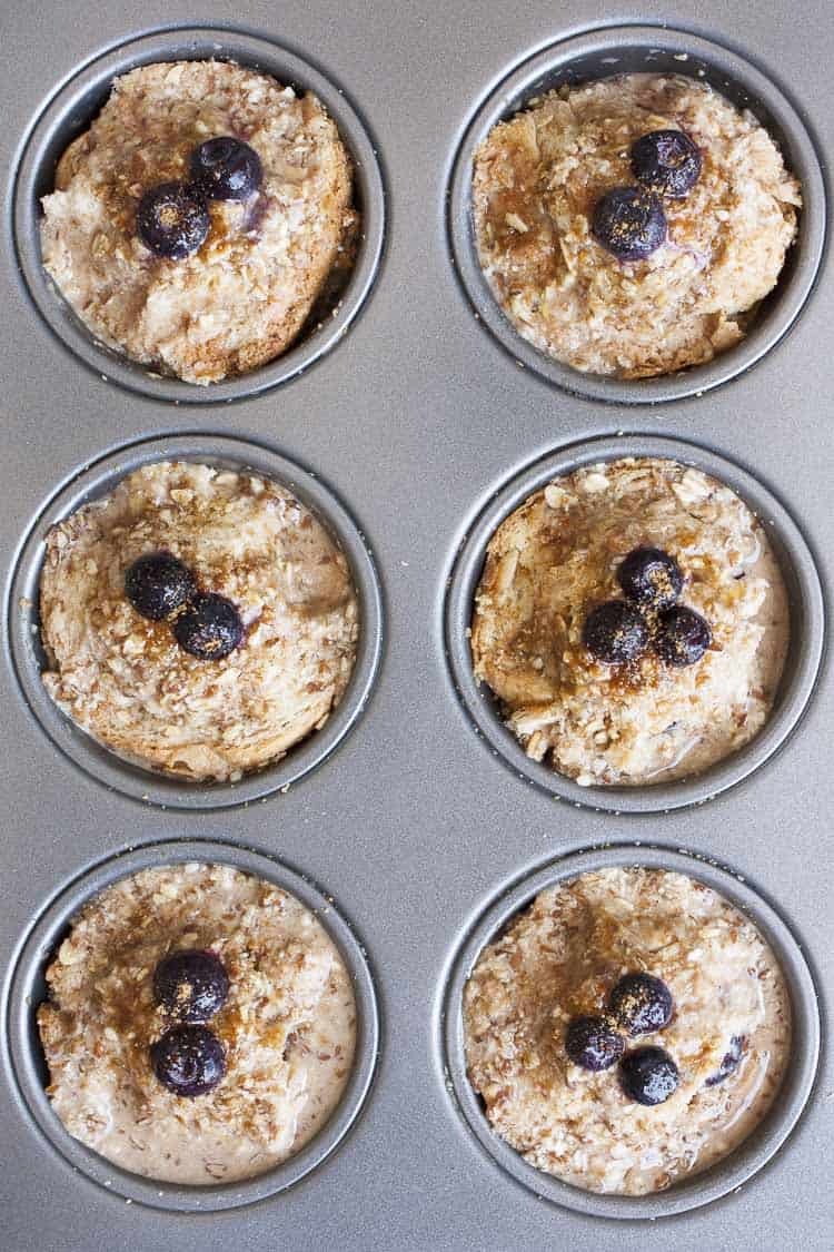 Mixing up breakfast in the most delicious way with blueberry flavored french toast made into vegan breakfast muffins! Easy to put together and prep ahead. #veganbreakfastrecipes #veganmuffins #sponsored #LoveMySilk Top view of uncooked blueberry french toast muffins in a muffin tin