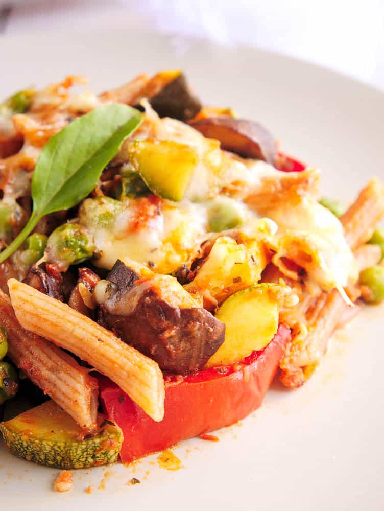 Close up of Vegetarian Pasta Bake with roasted vegetables on a white plate