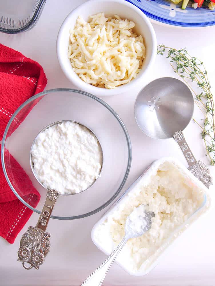 Ricotta and parmesan cheeses in bowls
