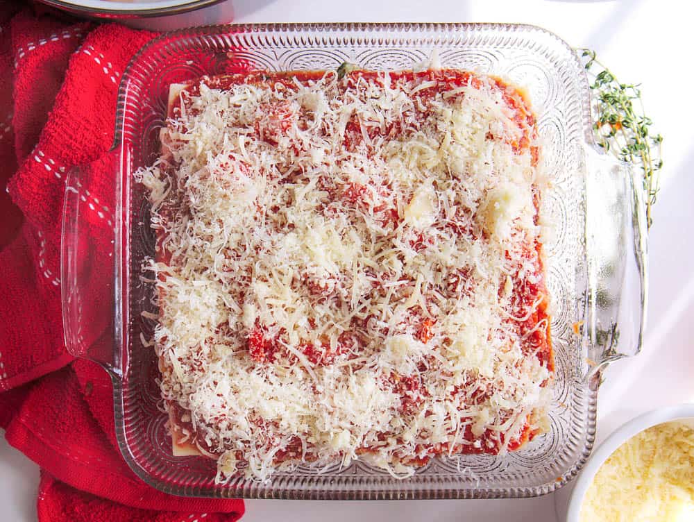 Parmesan grated on top of the unbaked healthy veggie lasagna