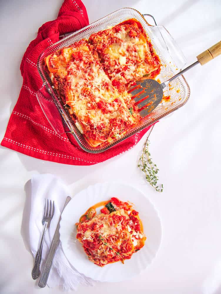 Top shot of the Healthy Vegetable Lasagna in a casserole and a portion served on a white plate