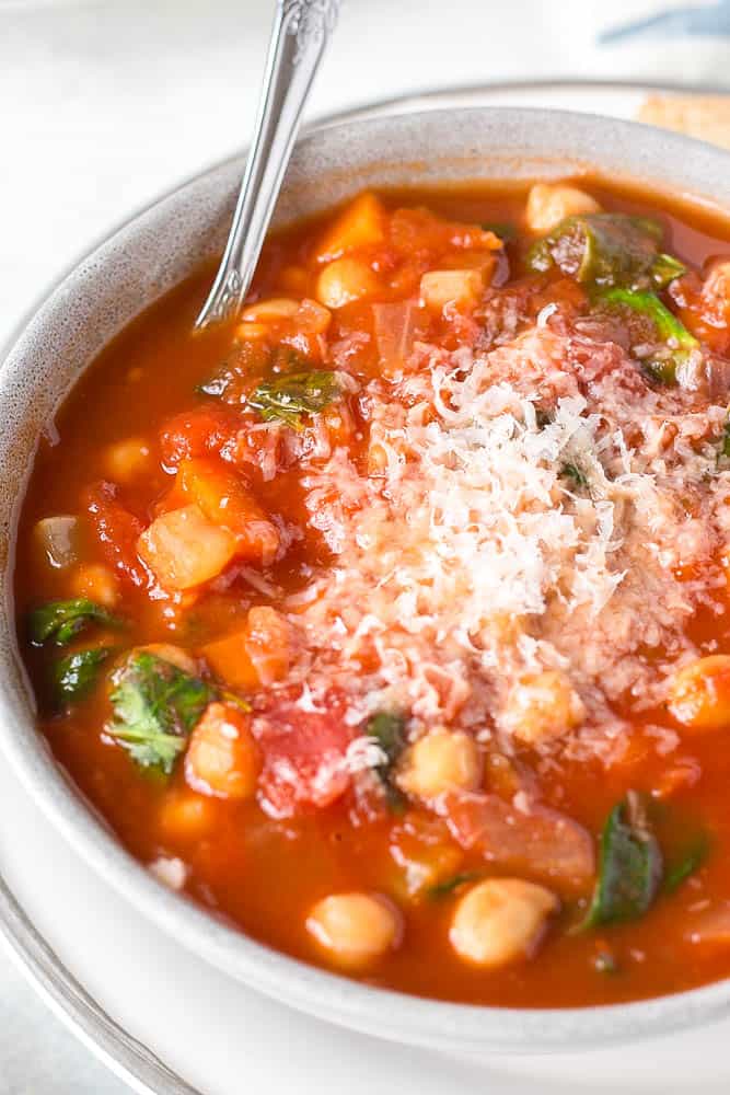 A close up of Italian chickpea soup topped with parmesan