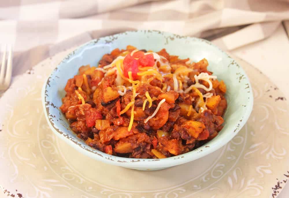 Spicy sweet potato breakfast hash topped with shredded cheese