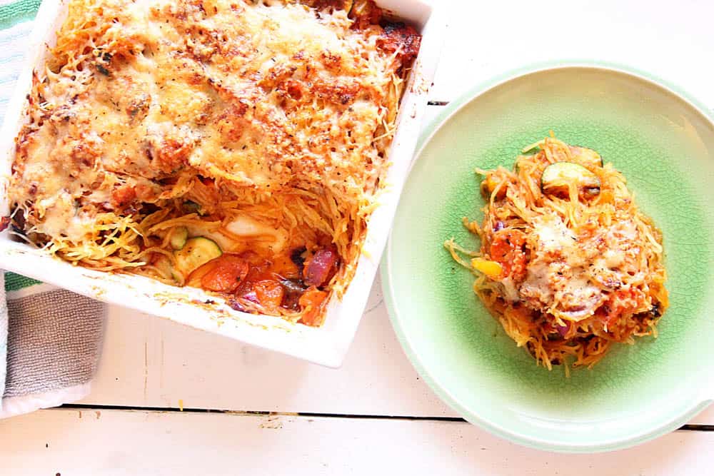 Spaghetti Squash casserole in a casserole dish and served on a plate