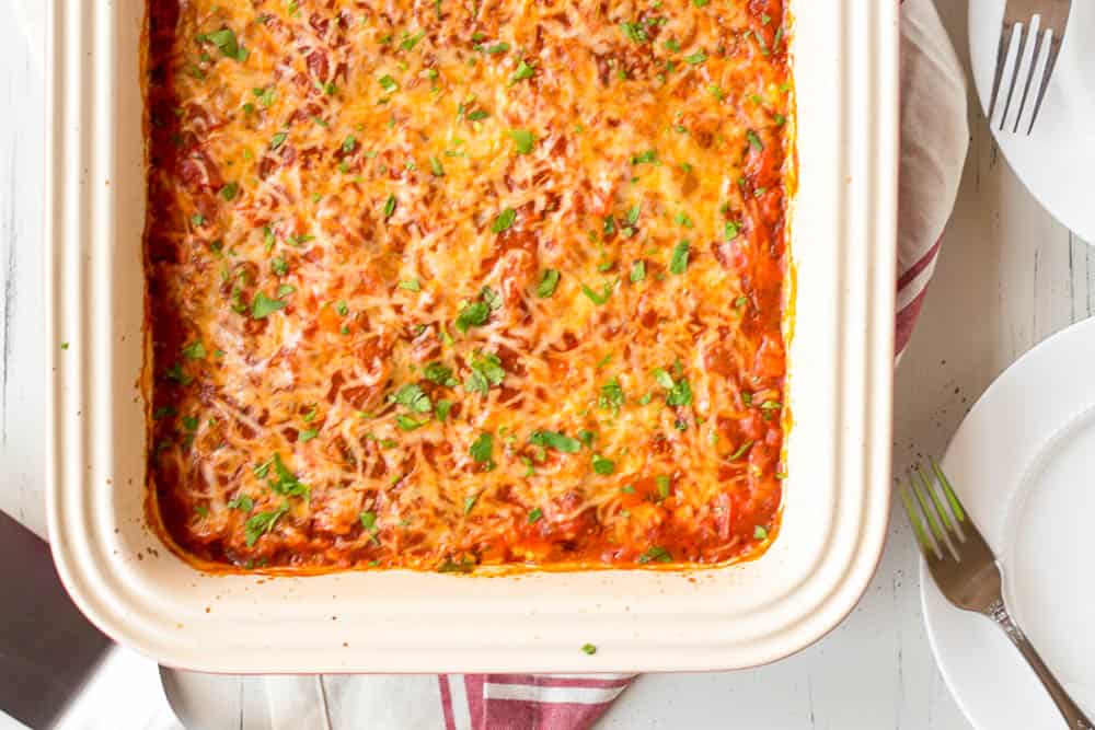 Low carb zucchini lasagna in a white casserole dish