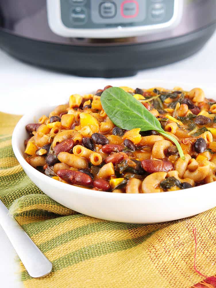 Instant Pot Vegetarian Chili Mac in a white bowl in front of the pressure cooker