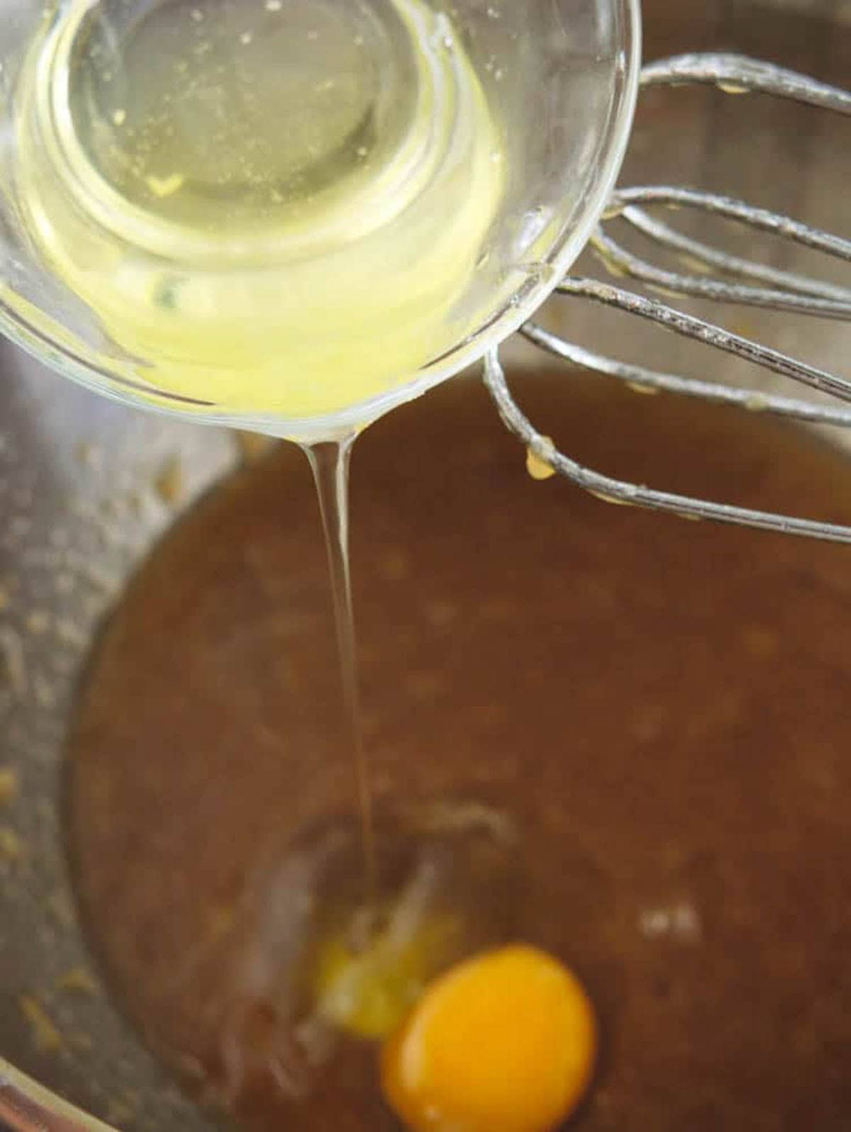 Eggs added to mixing bowl for cupcake batter.