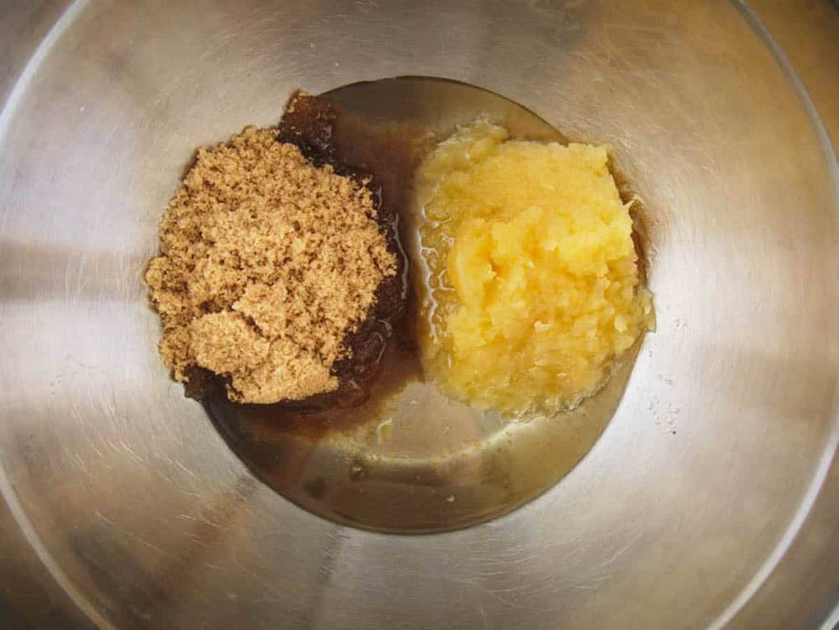 Sugar applesauce and oil added to a mixing bowl.