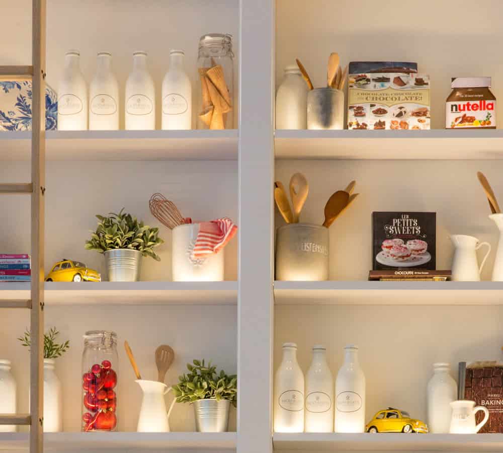 white wood pantry shelves with food storage containers