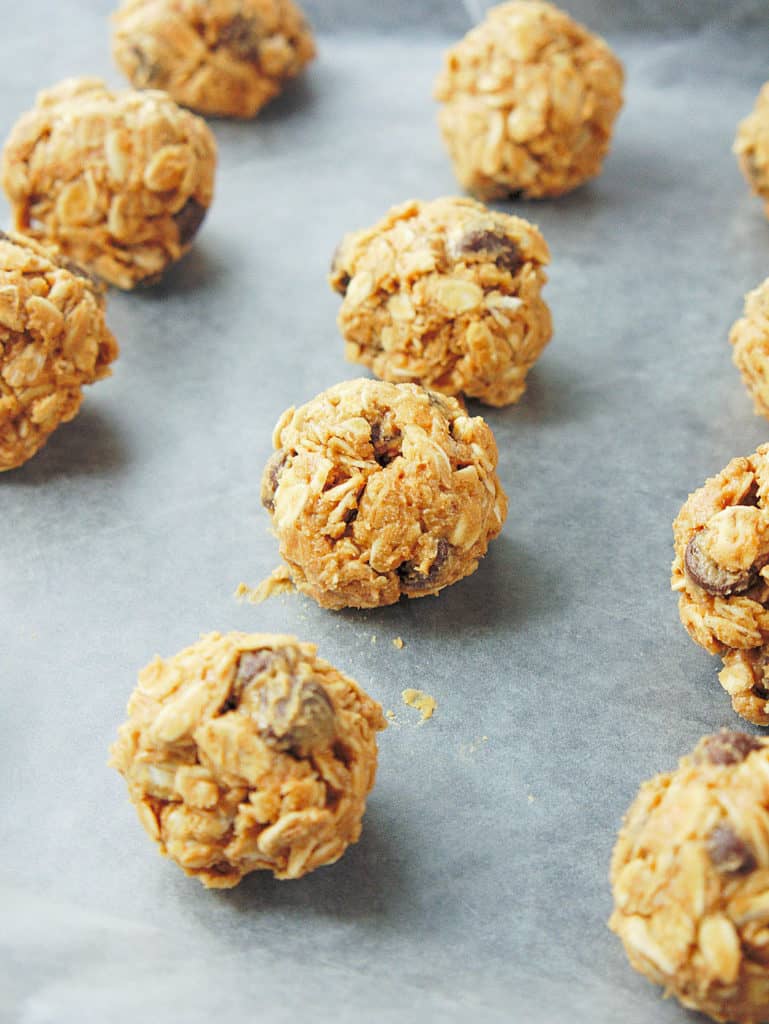 close up of bites placed on a parchment paper on a baking sheet