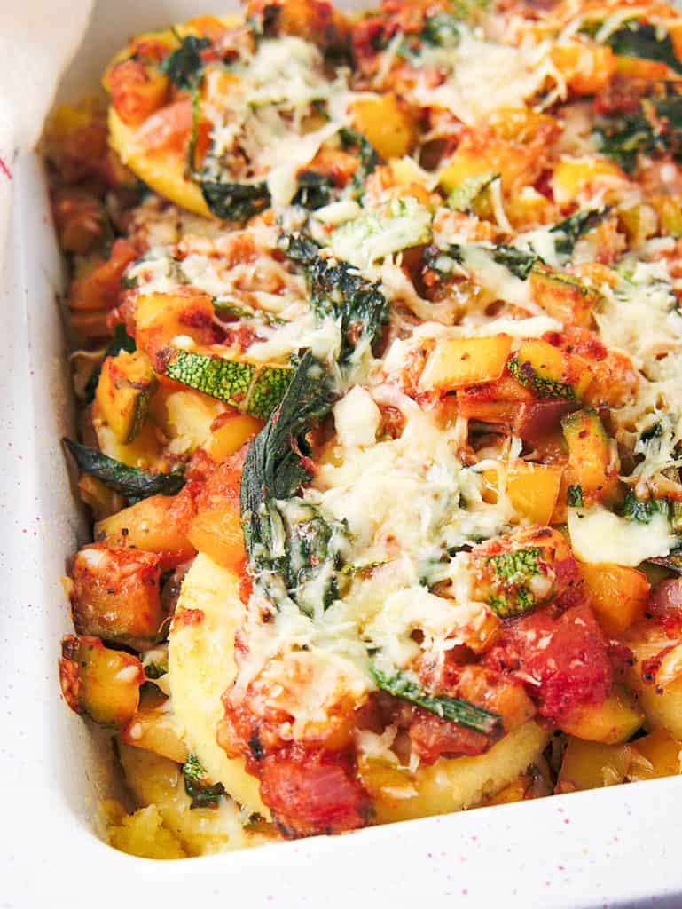 polenta garden vegetable lasagna in white casserole dish, served from the oven