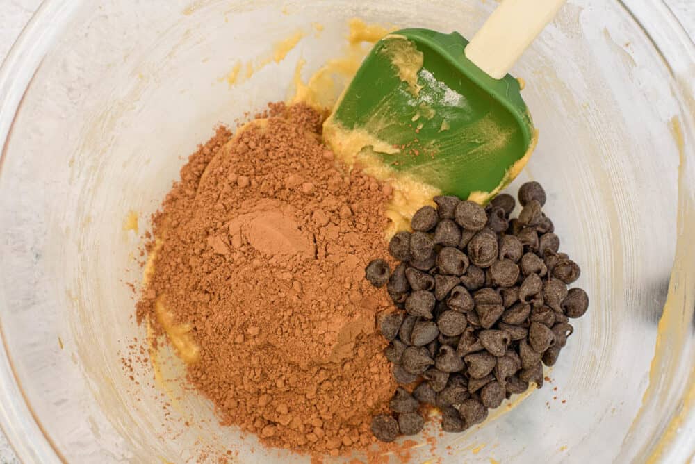 ingredients for pumpkin brownies combined in a glass bowl