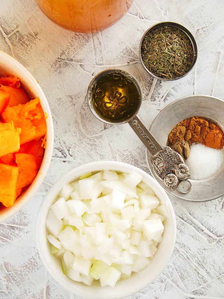 ingredients for butternut squash bisque: spices, onion, garlic, butternut squash