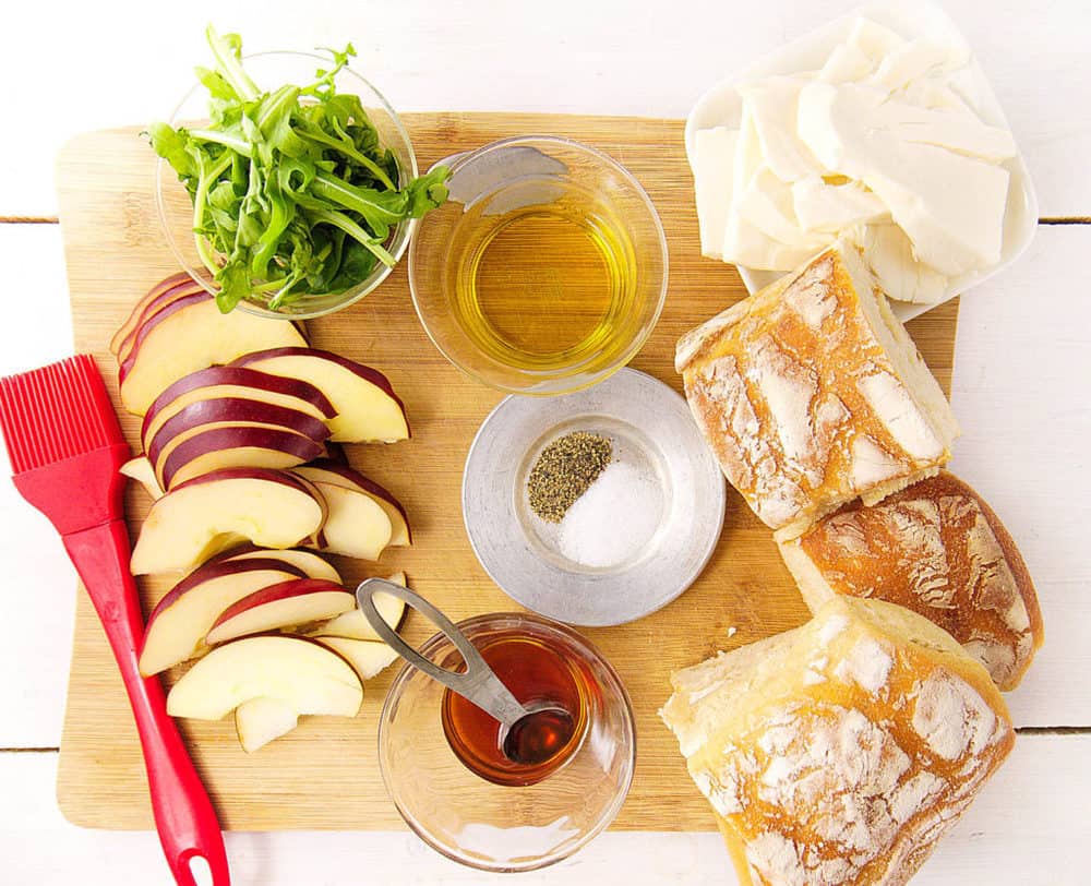 gourmet grilled cheese sandwich ingredients: baguette, arugula, pear, olive oil, honey, cheese, salt and pepper