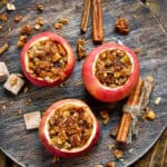 baked apples stuffed with spiced sprouted quinoa, granola, nuts, fruit - top view on a grey plate