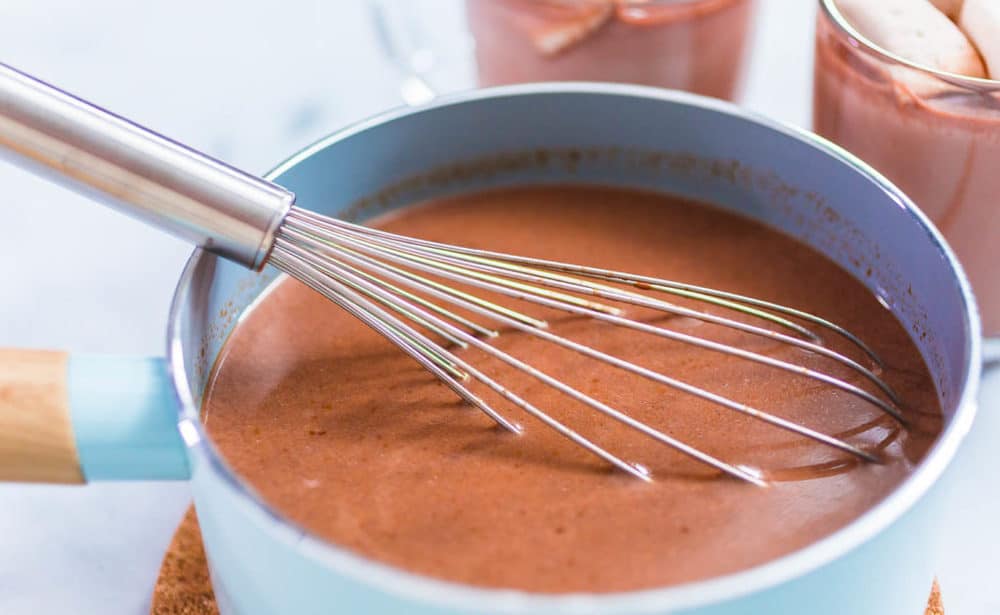 hot chocolate being whisked in a pan