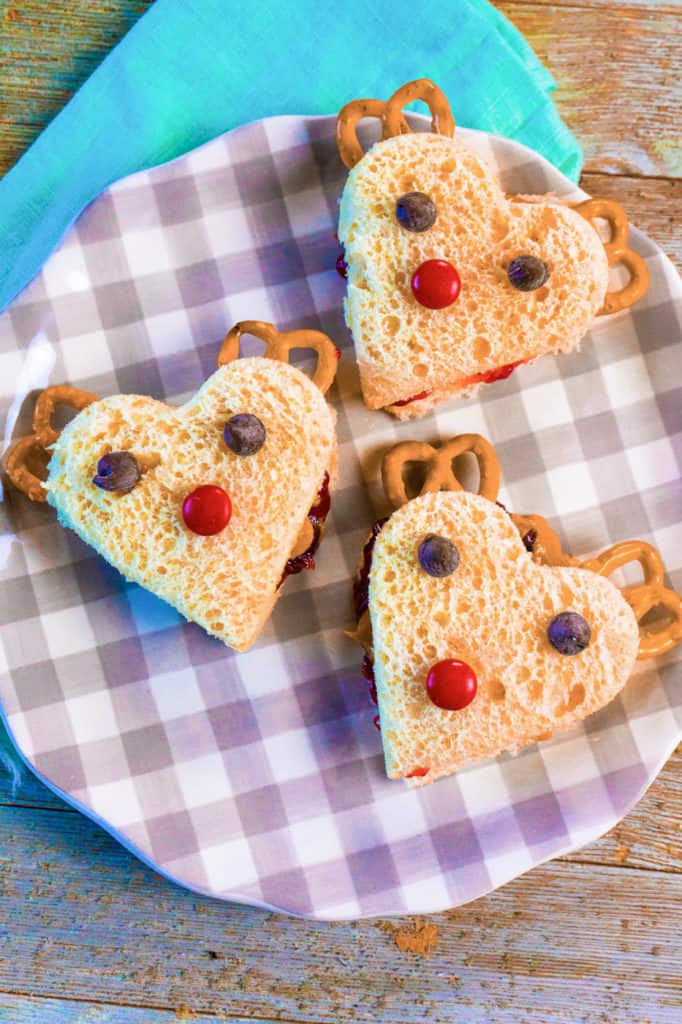 reindeer holiday sandwiches on a checkered plate with a blue napkin, top view