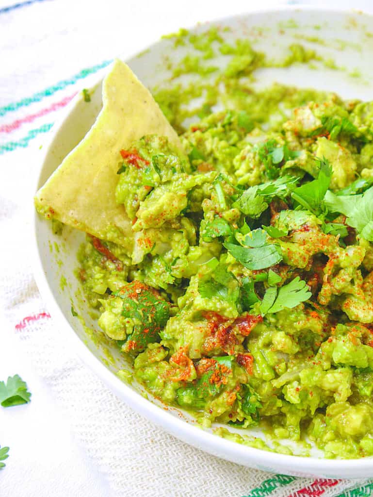 guacamole in a bowl with a chip