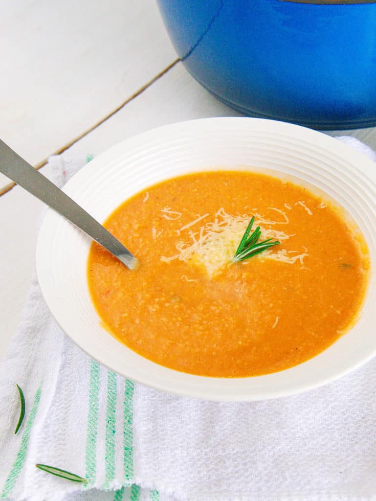 italian chickpea soup served in a white bowl with a spoon