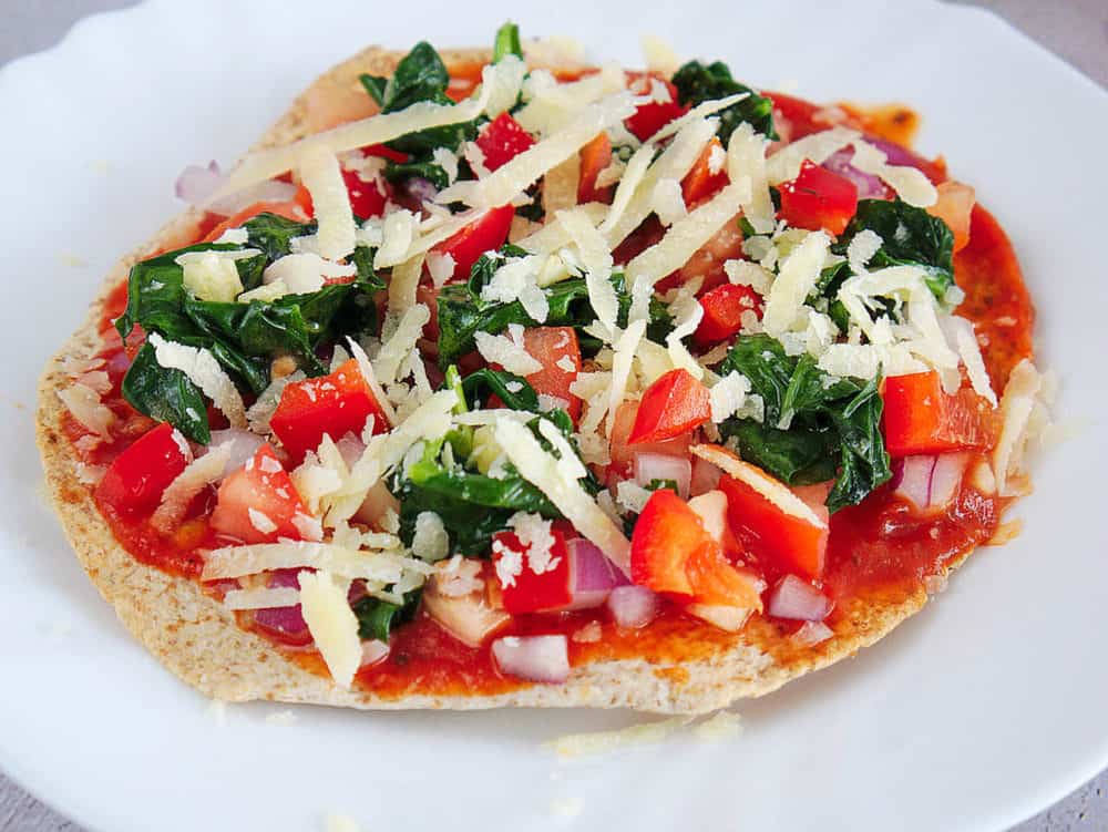 tortilla topped with pizza sauce, veggies, cheese