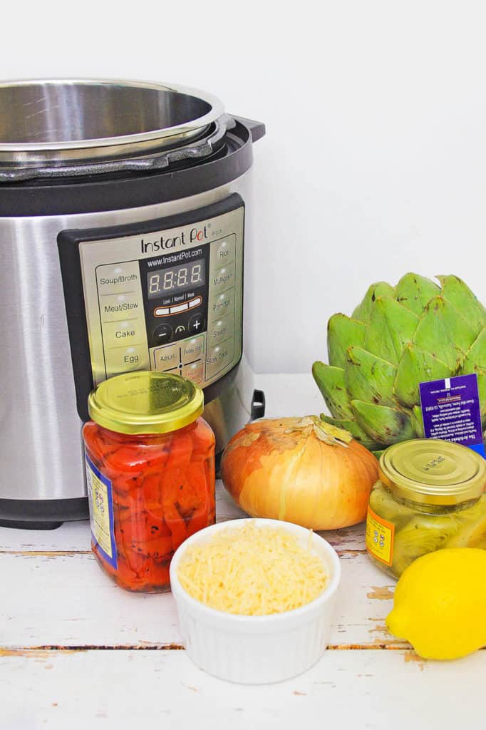 instant pot risotto ingredients (artichokes, roasted red peppers, onion, cheese, etc. next to the instant pot)