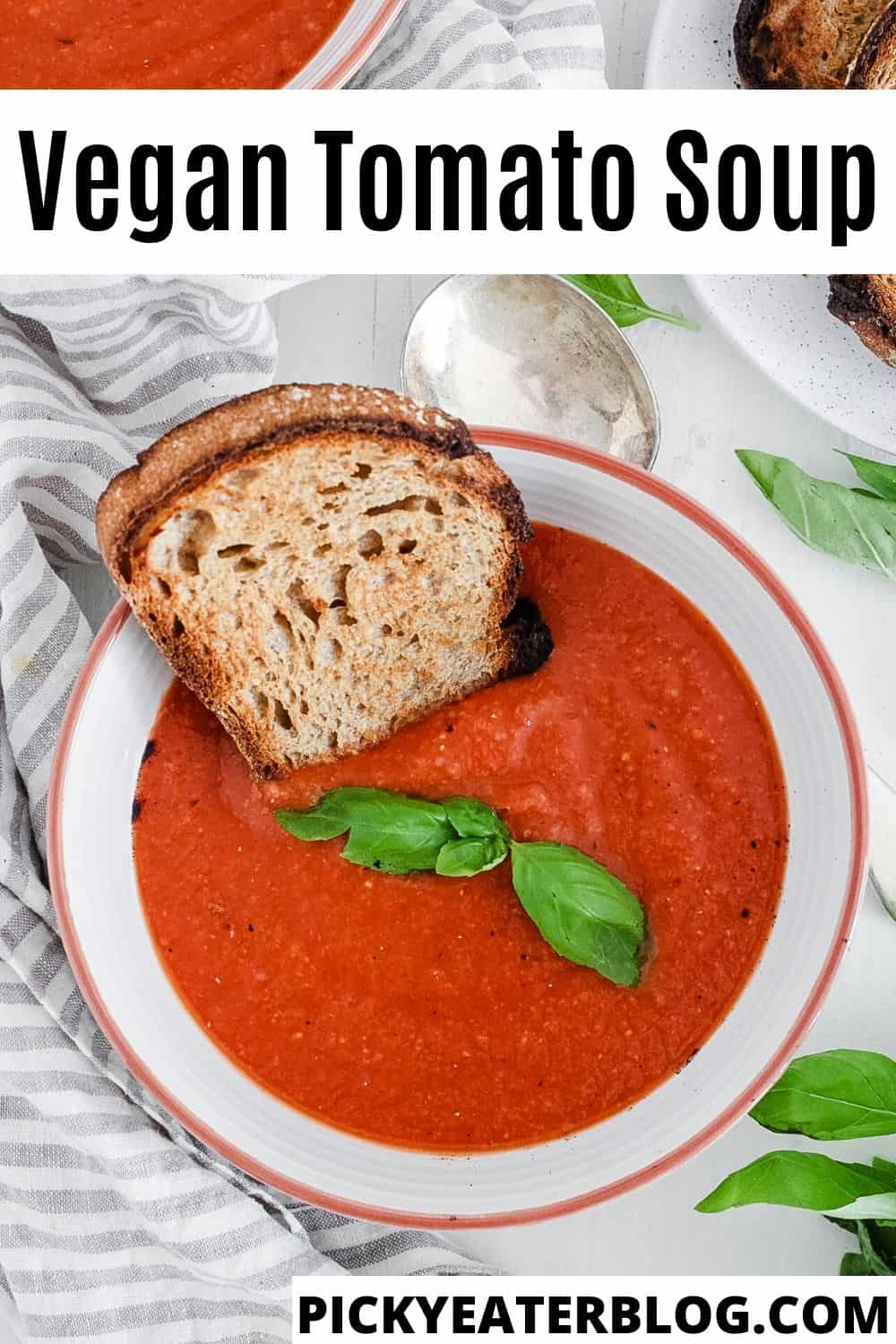 best easy healthy homemade vegan tomato soup recipe in a bowl with basil and crusty bread