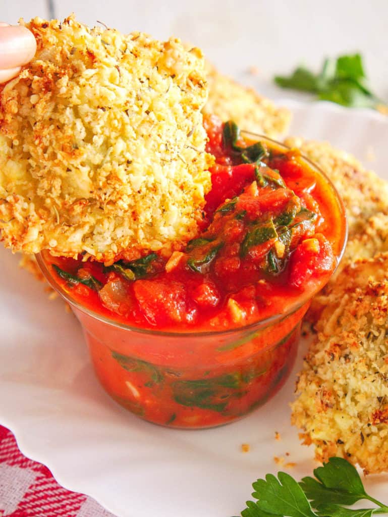 ravioli dunked in marinara sauce